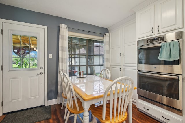 dining room with dark hardwood / wood-style flooring