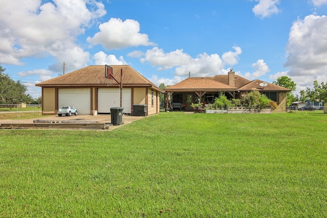 rear view of house with a lawn and a garage