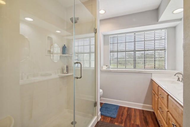 bathroom with walk in shower, toilet, hardwood / wood-style flooring, and vanity