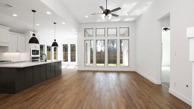 kitchen featuring pendant lighting, appliances with stainless steel finishes, ceiling fan, and dark hardwood / wood-style floors