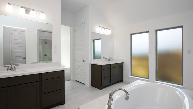 bathroom featuring vanity, tile patterned floors, lofted ceiling, and independent shower and bath