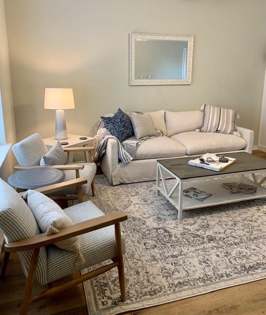 living room with baseboards and wood finished floors