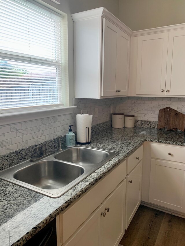 kitchen featuring a healthy amount of sunlight, decorative backsplash, dark hardwood / wood-style flooring, and white cabinets