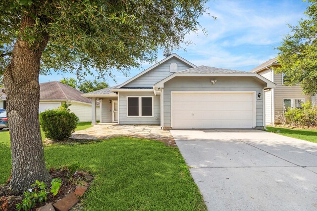 ranch-style house with a garage and a front yard