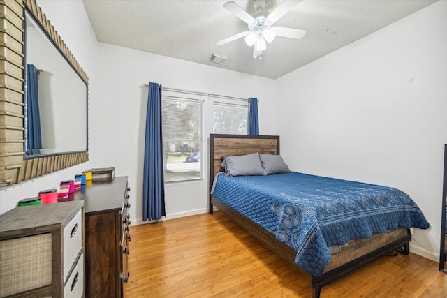 bedroom with ceiling fan and light hardwood / wood-style flooring