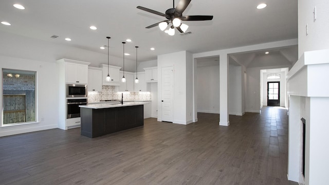 17711 Monarch Vista Ln, Conroe, TX 77302 - kitchen with appliances with stainless steel finishes, recessed lighting, open floor plan, tasteful backsplash, and white cabinetry
