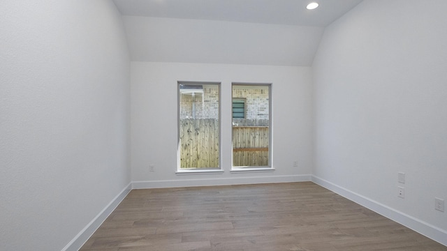 17711 Monarch Vista Ln, Conroe, TX 77302 - unfurnished room with vaulted ceiling, wood finished floors, and recessed lighting