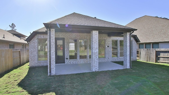 17711 Monarch Vista Ln, Conroe, TX 77302 - rear view of house with a fenced backyard, a patio, brick siding, and roof with shingles