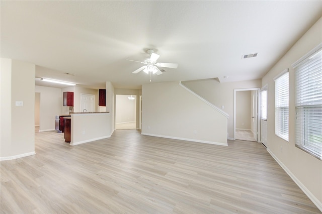 unfurnished living room featuring light hardwood / wood-style floors and ceiling fan