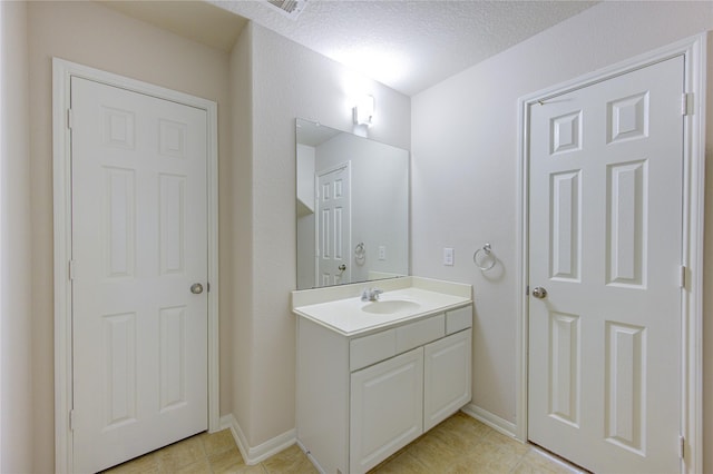 bathroom featuring vanity and a textured ceiling