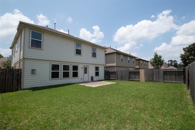 back of property featuring a lawn and a patio