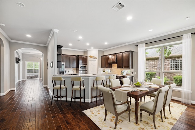 dining space featuring a wealth of natural light, hardwood / wood-style flooring, and ornamental molding