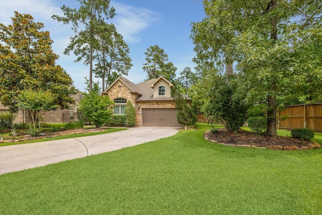 view of front of house with a front yard and a garage