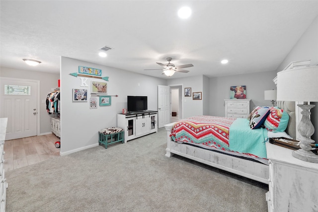 carpeted bedroom featuring ceiling fan and a closet