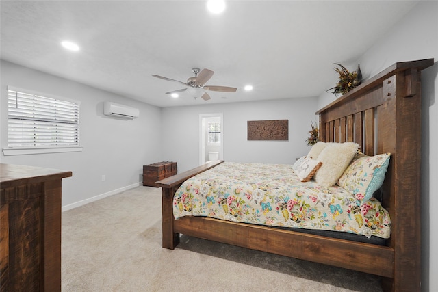 carpeted bedroom with ceiling fan and a wall mounted AC