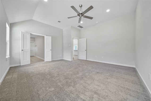 unfurnished bedroom with lofted ceiling, light colored carpet, and ceiling fan