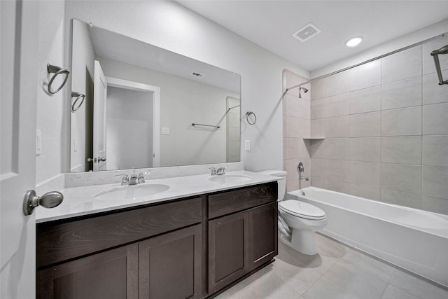 full bathroom featuring vanity, tiled shower / bath combo, toilet, and tile patterned floors