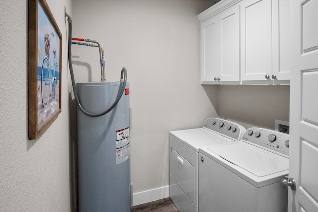 washroom with separate washer and dryer, dark hardwood / wood-style floors, water heater, and cabinets