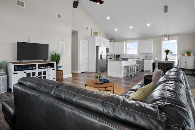 living room featuring ceiling fan, high vaulted ceiling, sink, and dark hardwood / wood-style flooring