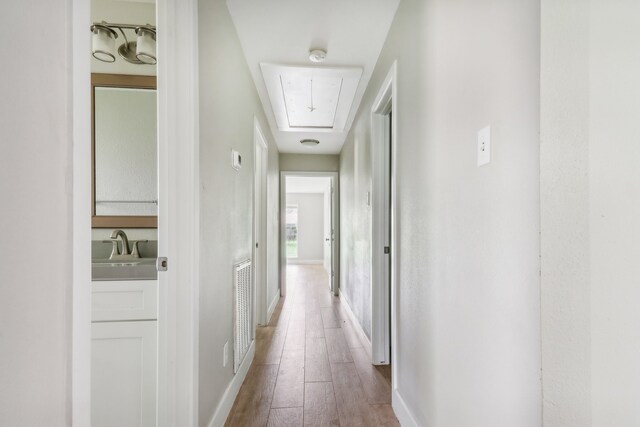 hall with sink and hardwood / wood-style flooring