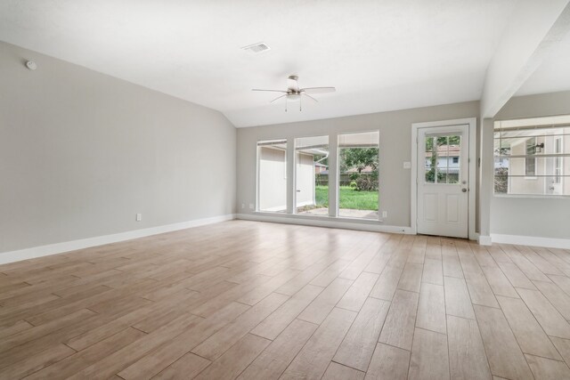 unfurnished living room with light wood-type flooring, vaulted ceiling, and ceiling fan