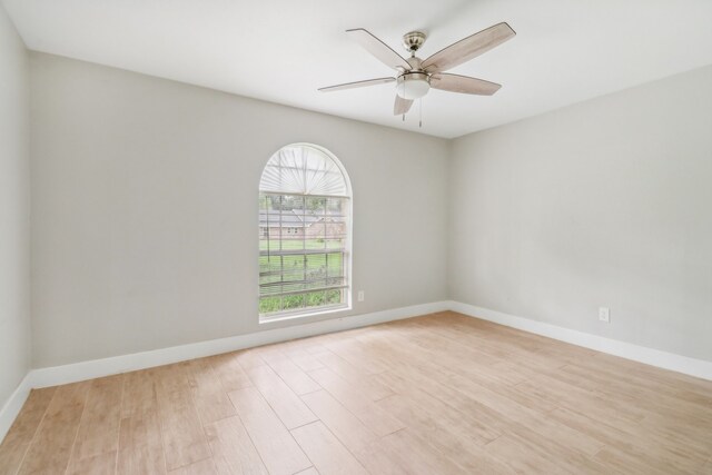 empty room featuring ceiling fan and light hardwood / wood-style flooring