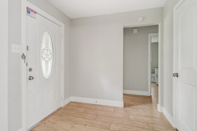 foyer entrance with light hardwood / wood-style flooring