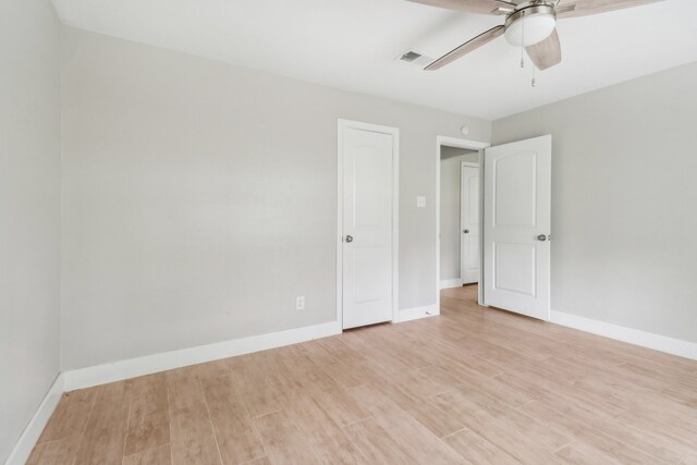 empty room with light hardwood / wood-style flooring and ceiling fan