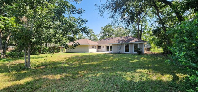 rear view of house with a yard