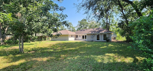 exterior space featuring a lawn and fence