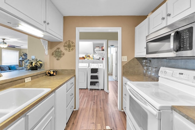 kitchen with ceiling fan, white cabinets, washing machine and dryer, electric stove, and light hardwood / wood-style floors