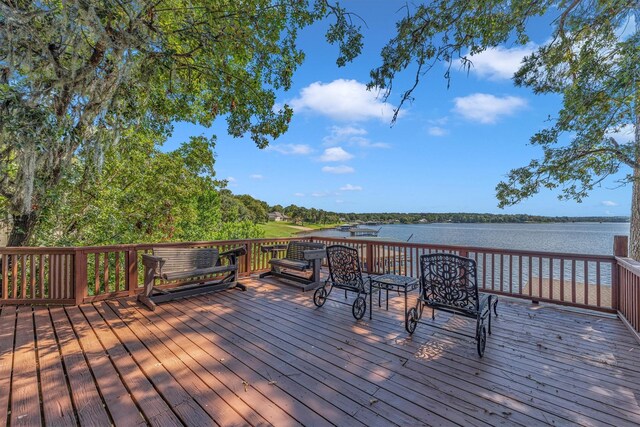 wooden terrace featuring a water view