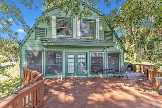 rear view of property featuring a deck