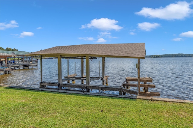 view of dock featuring a lawn and a water view