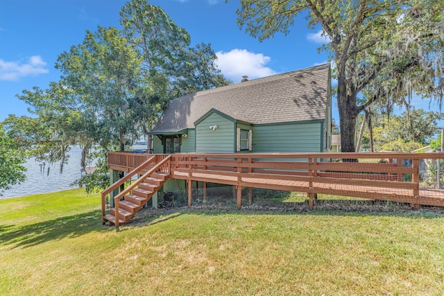 back of house featuring a deck with water view and a yard