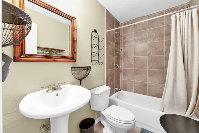 full bathroom featuring shower / bath combination with curtain, sink, tile patterned flooring, and toilet