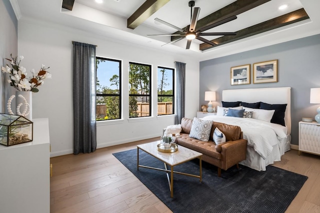 bedroom featuring ceiling fan, light wood-type flooring, a tray ceiling, beamed ceiling, and radiator heating unit