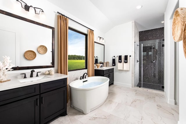 bathroom with vanity, vaulted ceiling, and shower with separate bathtub