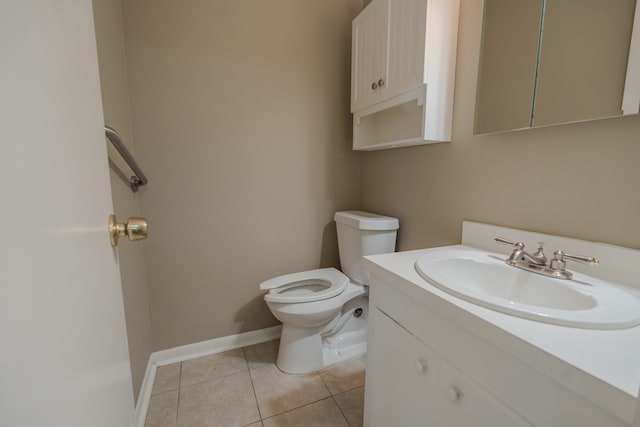 bathroom featuring toilet, vanity, and tile patterned floors