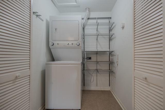 clothes washing area with stacked washer / dryer