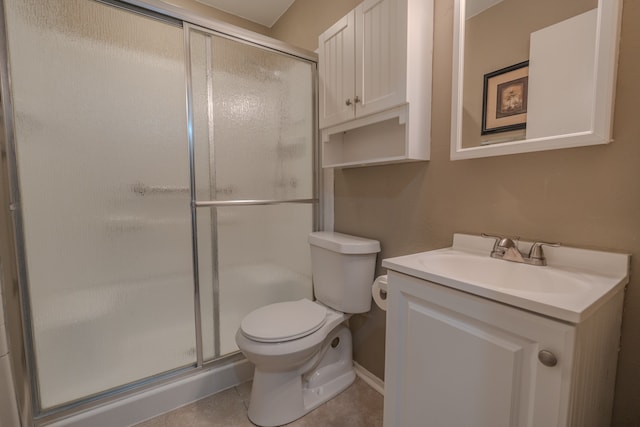 bathroom featuring a shower with door, vanity, tile patterned flooring, and toilet