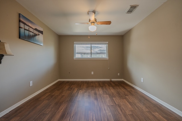 spare room with dark hardwood / wood-style floors and ceiling fan