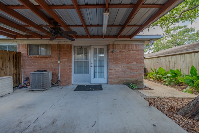 view of exterior entry with a patio, central AC unit, and ceiling fan