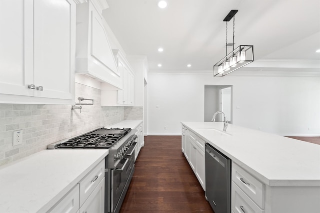 kitchen with appliances with stainless steel finishes, backsplash, a sink, and crown molding