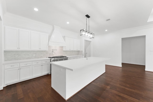 kitchen with light countertops, premium range hood, stove, and white cabinets