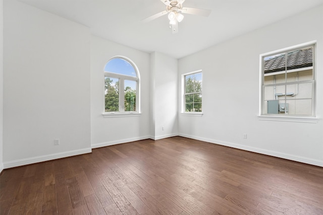 unfurnished room with ceiling fan, wood-type flooring, and baseboards