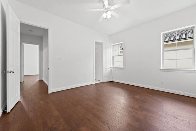 unfurnished bedroom featuring a ceiling fan, dark wood-style flooring, and baseboards