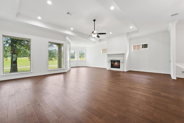 unfurnished living room featuring dark wood-style floors, ceiling fan, a glass covered fireplace, and visible vents