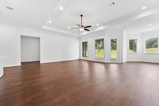 unfurnished living room with recessed lighting, visible vents, baseboards, dark wood-style floors, and a tray ceiling