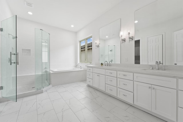 full bathroom with a bath, marble finish floor, a sink, and a stall shower